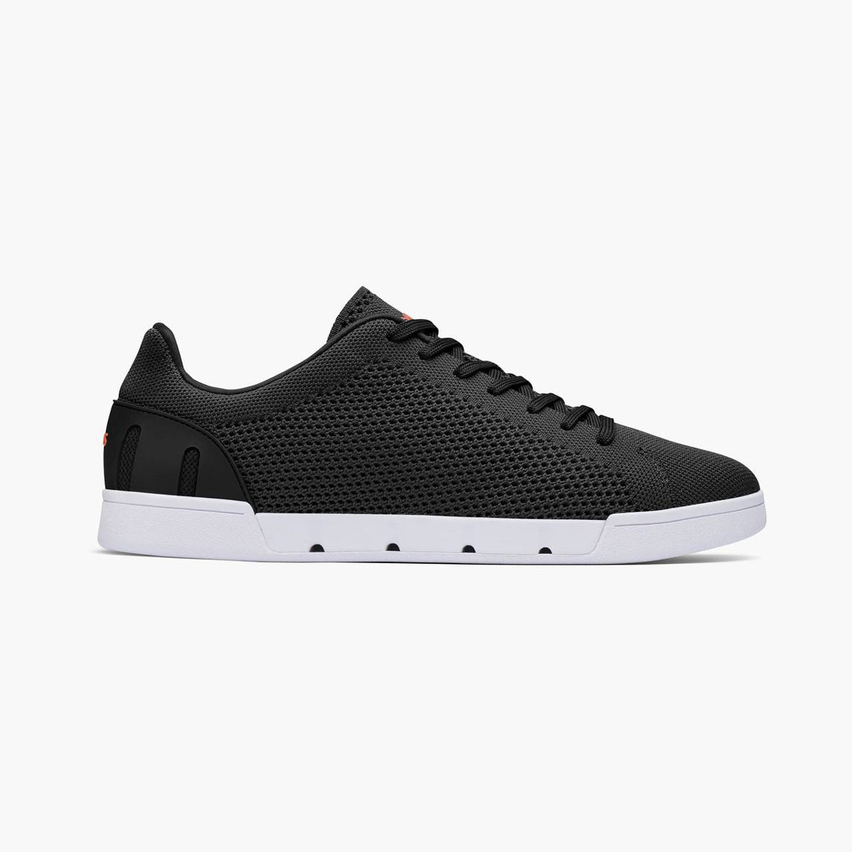Black slip-on sneaker with white sole on a light gray background. SWIMS Sneakers available at Sakks Menswear in Southampton.