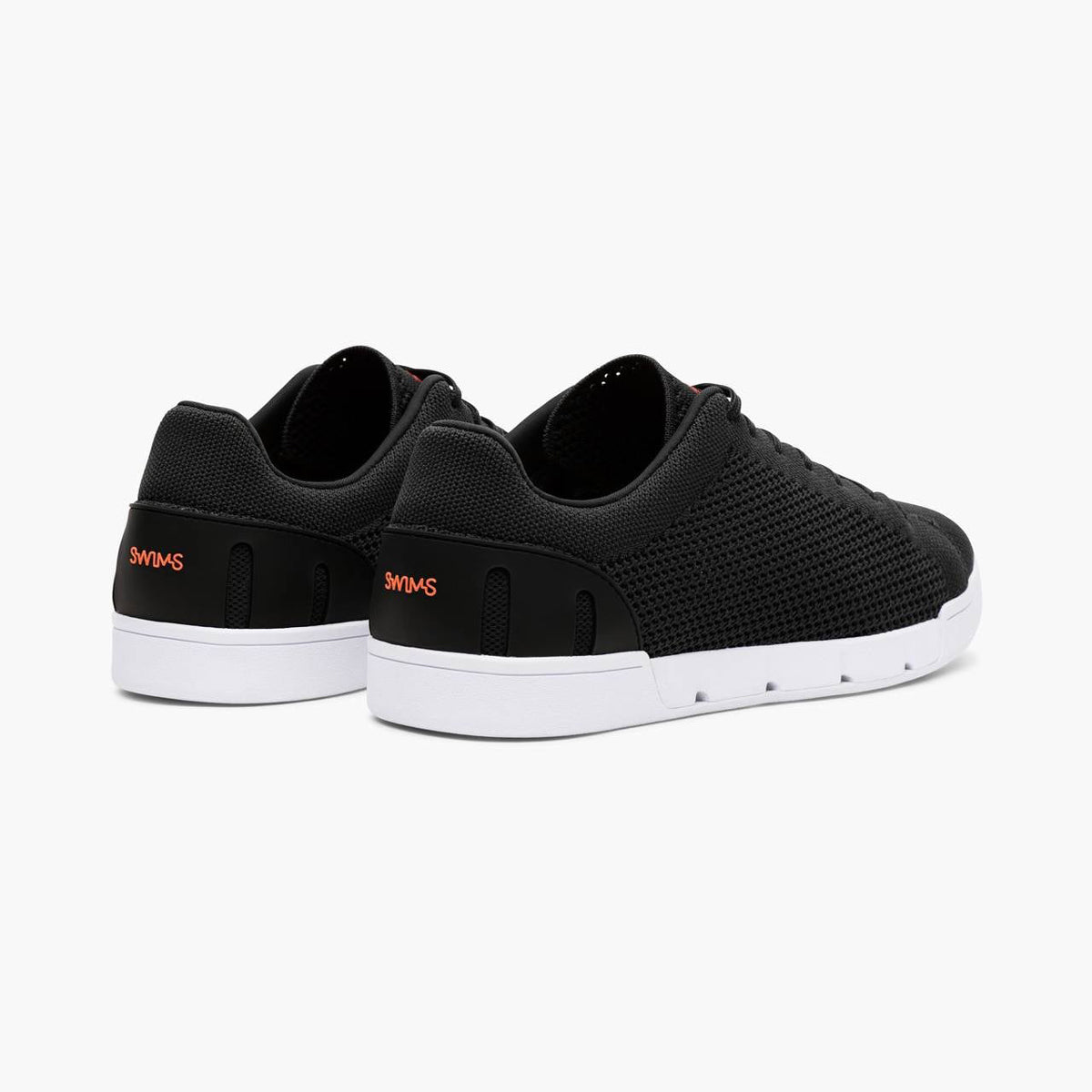 Black sneakers with white soles on a white background. SWIMS Sneakers available at Sakks Menswear in Southampton.