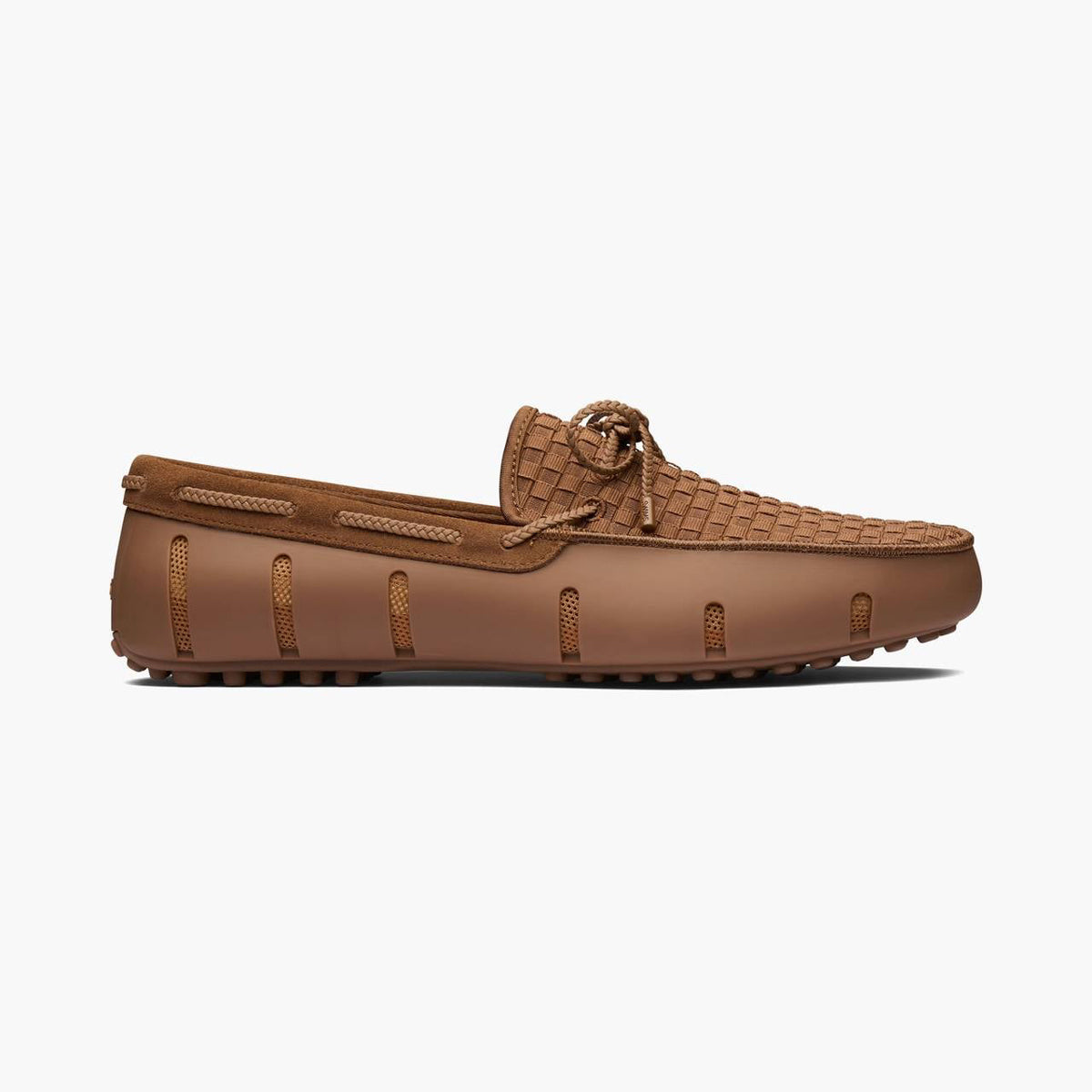 A single brown leather driving loafer with a woven toe cap and matching laces, shown in a side profile on a light gray background. SWIMS Loafers available at Sakks Menswear in Southampton.