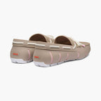 A pair of beige slip-on clogs with white rope-style trim and pink stitching details, shown from a three-quarters angle on a light gray background. SWIMS Loafers available at Sakks Menswear in Southampton.