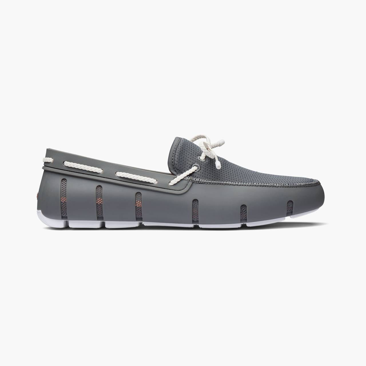 Brown slip-on shoe with white sole on a white background. SWIMS Loafers available at Sakks Menswear in Southampton.