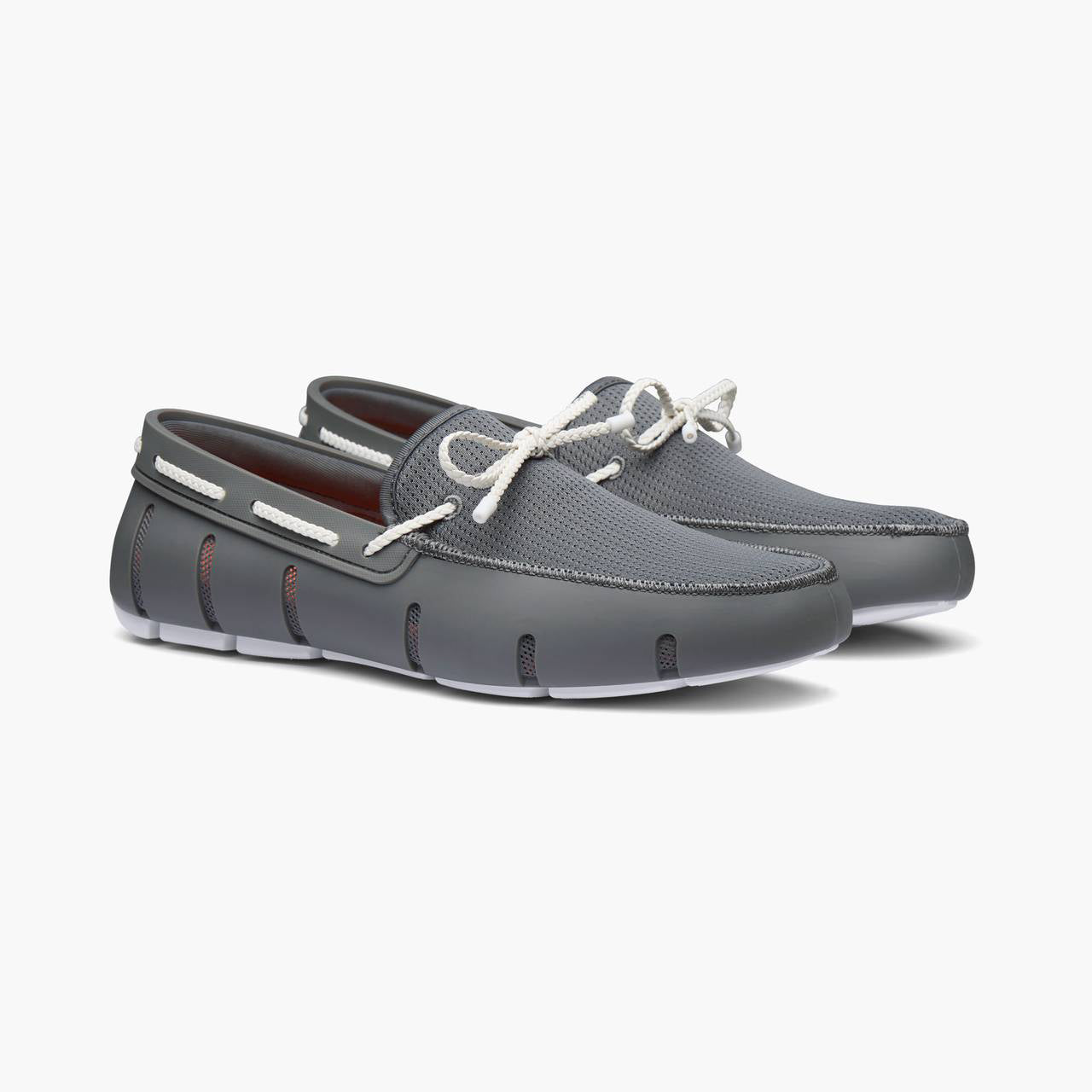 Black and white loafers with gold accents on a white background. SWIMS Loafers available at Sakks Menswear in Southampton.