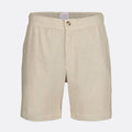 Beige cotton shorts with an elastic waistband and a single button closure, shown against a light gray background. SWIMS Shorts available at Sakks Menswear in Southampton.