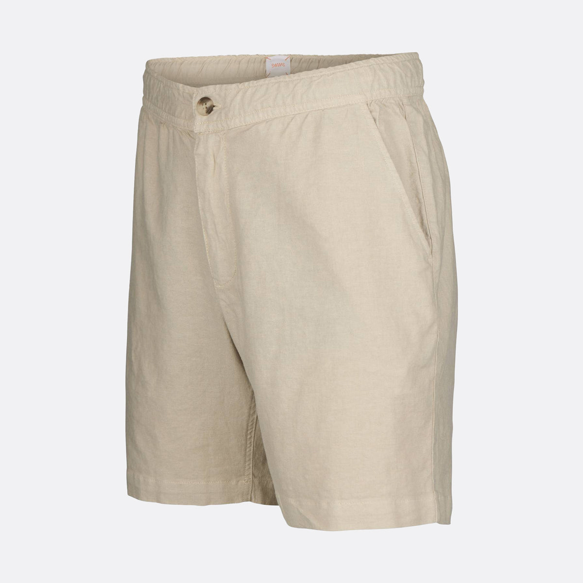 Beige linen shorts with a buttoned waistband and side pockets, shown on a light gray background. SWIMS Shorts available at Sakks Menswear in Southampton.