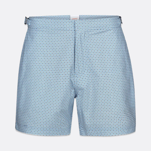 Light blue shorts with a small repeating dark blue geometric pattern, shown flat against a light gray background. SWIMS Swim Shorts available at Sakks Menswear in Southampton.