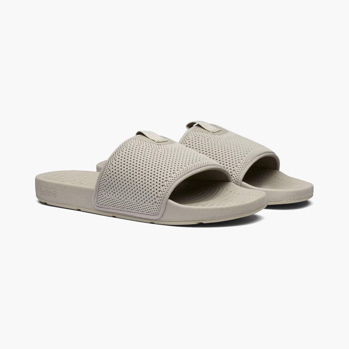 A pair of SWIMS slide sandals in a light grey colour, featuring a perforated mesh upper strap and a contoured foam sole, shown against a plain light gray background. SWIMS Slides available at Sakks Menswear in Southampton.