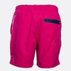 Bright pink athletic shorts with an elastic waistband and a dark navy zippered pocket on the back, shown against a light gray background. SWIMS Swimshorts available at Sakks Menswear in Southampton.