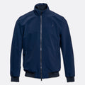 A navy blue lightweight zip-up jacket with a stand-up collar, ribbed cuffs, and a ribbed hem, shown against a light gray background. UBR Jacket available at Sakks Menswear in Southampton.