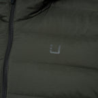 Close-up of an olive green puffer jacket with a dark zipper and a small gray stylized logo on the chest. UBR Jacket available at Sakks Menswear in Southampton.