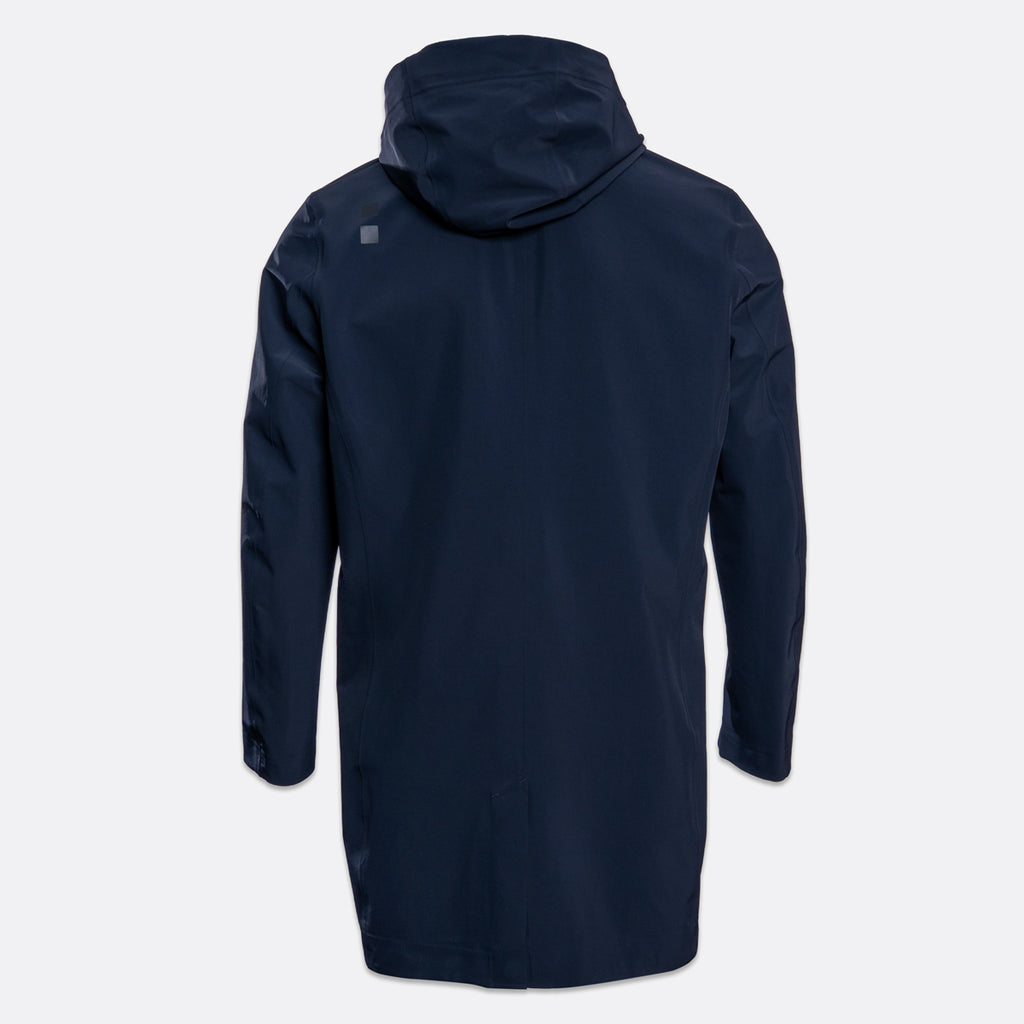 A dark navy hooded jacket shown from the back, featuring a small square logo on the upper left shoulder, set against a light gray background. UBR Jacket available at Sakks Menswear in Southampton.