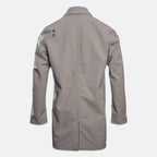 A light gray long-sleeve utility jacket shown from the back, featuring a small dark gray geometric logo on the upper left shoulder, set against a plain light gray background. UBR Jacket available at Sakks Menswear in Southampton.