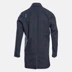 A dark navy blue long-sleeve jacket shown from the back, featuring a subtle gray geometric logo on the upper left shoulder, set against a light gray background. UBR Jacket available at Sakks Menswear in Southampton.