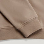 Close-up detail of a crewneck sweatshirt showing the ribbed cuff and hem in a warm taupe-brown colour. Belstaff Sweatshirt. Sakks Menswear Southampton.