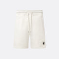 Off-white fleece drawstring shorts with a small black logo patch on the lower left leg, shown against a light gray background. Belstaff Sweatshorts. Sakks Menswear Southampton.
