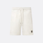 Off-white fleece drawstring shorts with a small black logo patch on the lower left leg, shown against a light gray background. Belstaff Sweatshorts. Sakks Menswear Southampton.