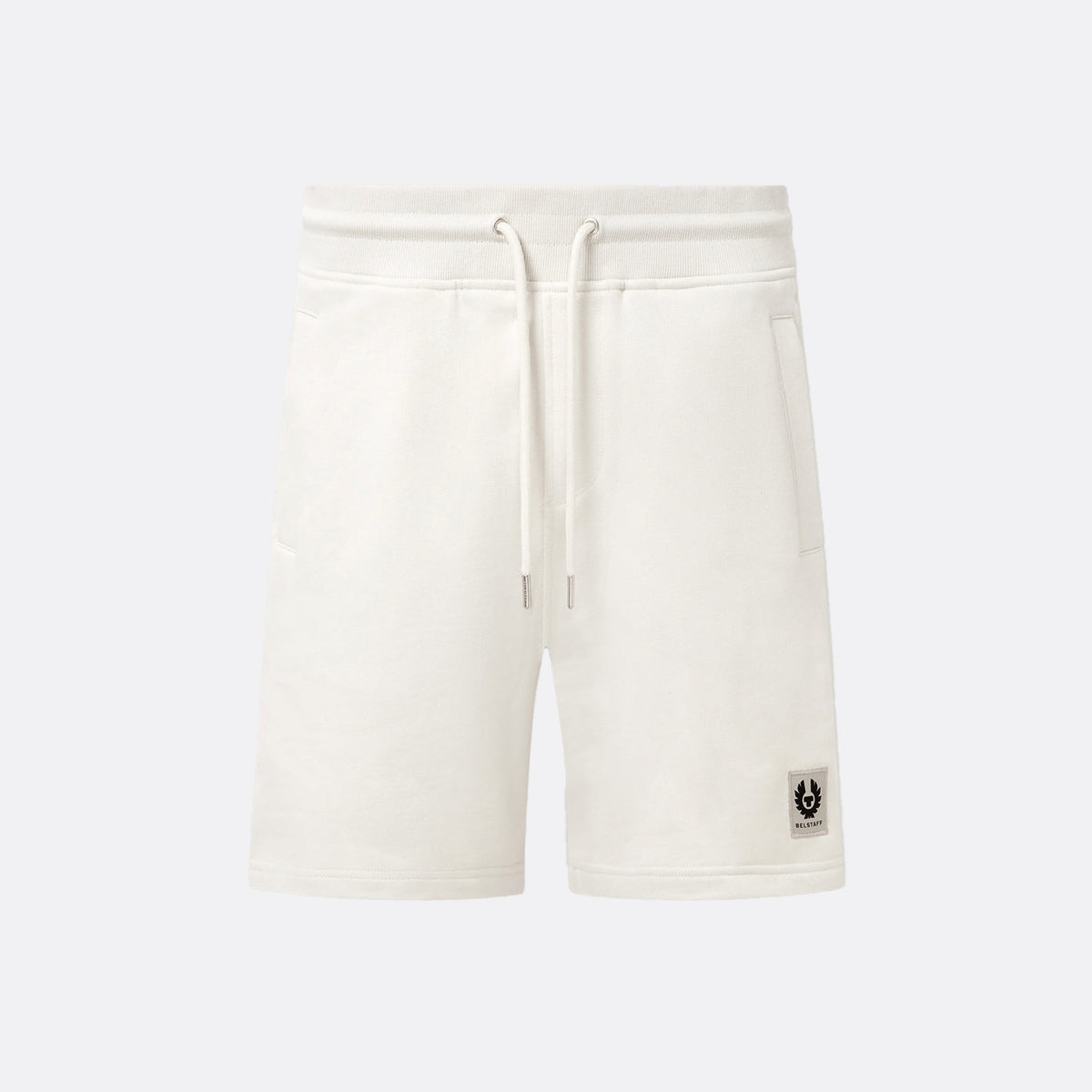 Off-white fleece drawstring shorts with a small black logo patch on the lower left leg, shown against a light gray background. Belstaff Sweatshorts. Sakks Menswear Southampton.