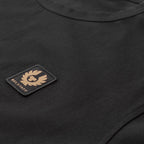 Close-up of a black crew-neck t-shirt featuring a rectangular black patch on the chest with a tan/gold embroidered winged logo and the text 'BEL STAFF'. Belstaff T-Shirt. Sakks Menswear Southampton.